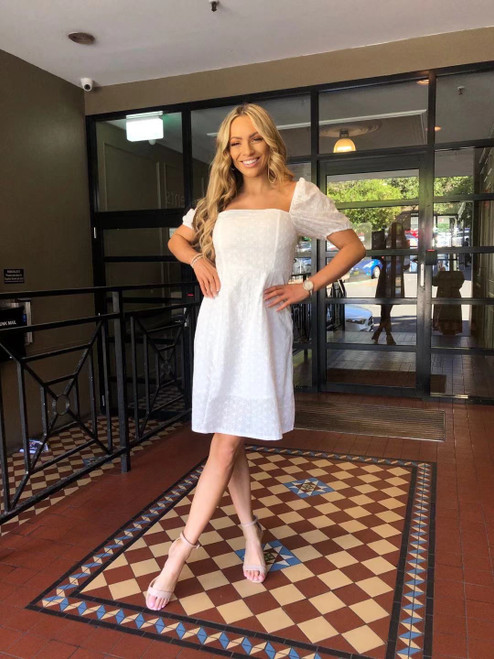 All the chic boho vibes just ooze out of our pretty Casey Broderie Anglaise Dress. This cotton dress features sweet puff sleeves and is perfect to wear absolutely anywhere!!! Pair with our Ibiza Strappy Slides in Camel or tan heels to complete the look.

This dress features:

Square-neckline
Shirred back panel
Puff sleeves
Lined
Colour: White 

Fabric: 100% Cotton

Size Guide: True to size. Stick with your usual size.