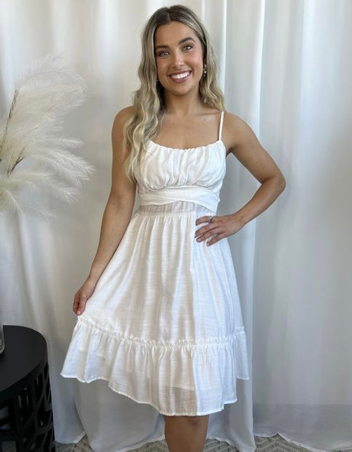 You are sure to love our sweet Angel dress, which is perfect for any summer day events! This chic dress features adjustable shoulder straps and a ruched bust with a square neckline, that is sure to have you wanting to wear her over and over again! Pair with nude heels gold accessories and you're good to go!

This dress features:

Square elasticised neckline
Ruched bust
Slim waistline
Adjustable shoulder straps
A-line skirt
Ruffled hemline with frill
Tie up waist
Invisible zip at centre back
Lined front top and skirt
Colour: White

Fabric: 80% Cotton, 20% Polyester; Lining: 100% Rayon

Size Guide: True to size. Please note that this dress has no stretch at the waist.