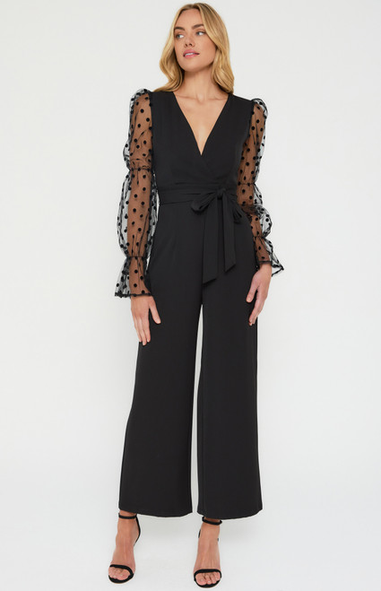 Step out in style at your next event in our stunning Alyssa Jumpsuit! With it's elegant detailed long sleeves, this dreamy jumpsuit is sure to turn heads. Pair with black strappy heels and gold statement jewellery to complete your look.

This jumpsuit features:

Cross front neckline with stay stitch
Velvet dot mesh contrast long sleeves with tiered elastic
Full length pants
Fitted waist panel for flattering fit
Removable waist tie detail
Centre back invisible zip
Fully lined
Colour: Black

Fabric: Main: 96% Polyester 4% Spandex. Sleeves and lining: 100% Polyester

Size Guide: True to size!