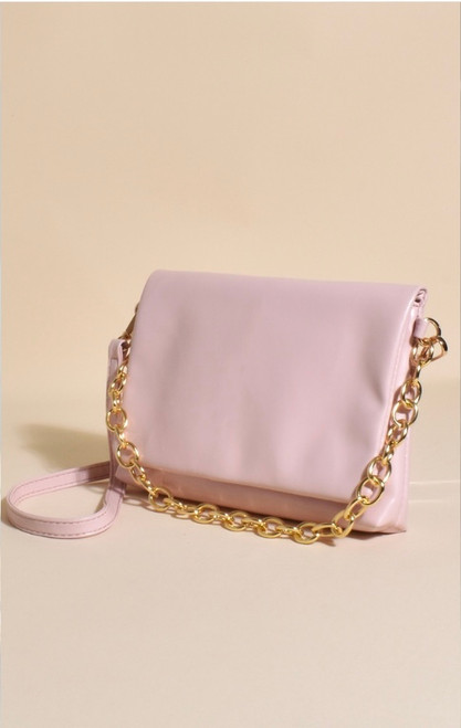 Our Isabelle Foldover Chain Bag is such a pretty piece! Featuring a gold statement chain that can be used as either a feature or a strap means this bag can be worn in a few different ways to refresh and elevate your look! 

This bag features:

Gold press stud closure
Gold chain strap
Removable faux leather strap
Internal pocket with zip 
Plenty of room for necessities
Colour: Pink and Gold

Material: Vegan Leather & Plated Metal

Measurements: L: 22cm, H: 17cm, D: 2cm