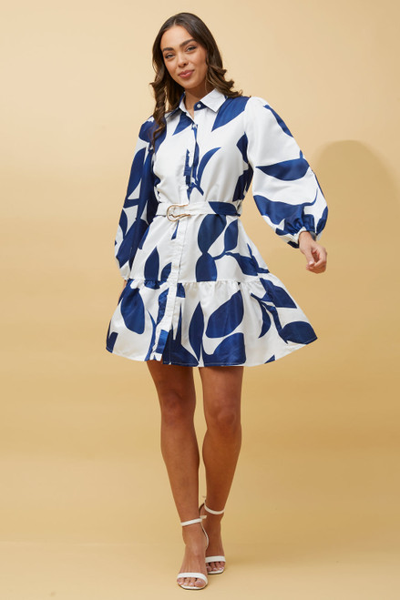 Discover our stylish Tamara Shirt Dress. This gorgeous mini dress features balloon sleeves, ruffle hemline and a removable belt to cinch you in or wear without the belt for a classic smock style silhouette. Pair with white strappy heels and you're ready to head out to brunch or any day event.

This dress features:

Smock style 
Collar
Functional button up front
Long, balloon sleeves
Removable belt
Ruffled hemline 
Unlined
Smooth satin feel
Colour: White with Navy Leaf Print

Fabric: 100% Polyester

Size Guide: True to size!