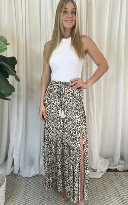 Our sweet Shiva Leopard Print Maxi Skirt is puurrfect for many occasions. Featuring 2 front splits and tassel tie details, it's sure to become one of your wardrobe staples this season. Pair this skirt with a graphic tee and our Colleen Ribbon Fedora in Tan to complete your chic boho look.

This skirt features:

Elasticised waist with drawstring waist tie and tassel details
2 front splits
Tiered
Ruffled hemline 
Relaxed style
Maxi length
Colour: Beige with Leopard Print

Fabric: 100% Rayon

Size Guide: True to size. Model is 157cm and wearing a size 8.