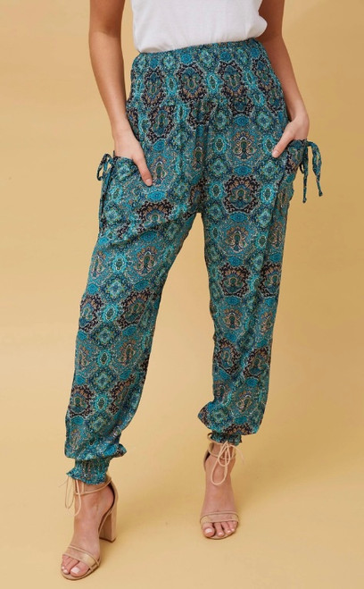Our gorgeous Eden Harem Pants are perfect for lounging around, doing yoga or just going about your day to day activities in. They're stylish, lightweight and comfortable and the side pokets make them practical! These pants will be on high rotation in you wardrobe for most of the year!

These pants feature:

High, shirred waist
Side pockets with non functional tie details
Shirred cuffs at the ankle
Flowy 
Colour: Green

Fabric: 100% Viscose

Size Guide: True to size