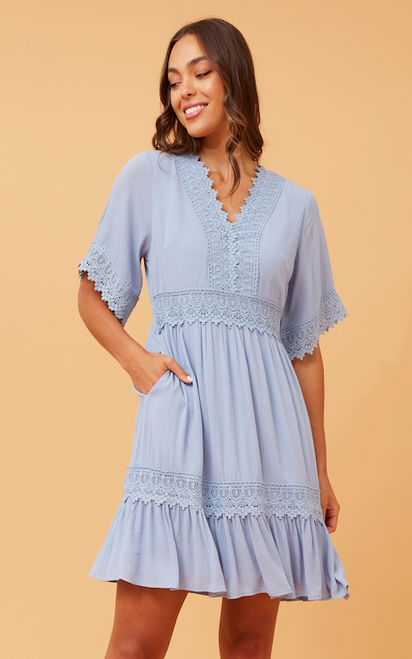 Step out in style in our Bohemia Mini Dress! This boho beauty will never go out of date and features gorgeous lace trim details, ruffled hemline and pockets!!! It is the perfect dress to wear to so many occasions such as Christenings, baby showers and brunch dates. Pair with wedged heels and gold accessories for a chic bohemian look.

This dress features:

V-neckline with lace trim detail
Short sleeves with lace trim cuffs
In seam side pockets
Lace trim on waist and hem
Ruffled hemline
Lined
Colour: Blue

Fabric: 100% Viscose

Size Guide: True to size. Model is 173cm tall and wears a Size 8.