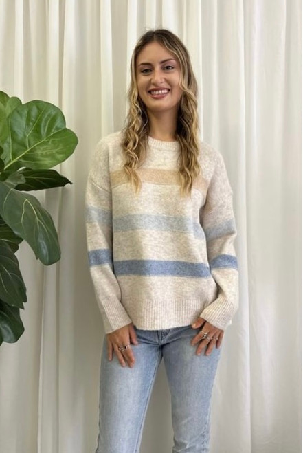 Our warm and cosy, wool blend Adeline Knit is super soft and comfy. The blue and tan stripe detailing adds a striking touch and the hi-low hemline covers you in all the right places. Dress this knit up with our Wet Look Skinny Jeans and ankle boots for a stunning look will love this winter!

This knit features:

Round ribbed neckline
Ribbed cuffs and hem
Hi-low hemline
Side splits
Dropped shoulders
Wool blend
Has some stretch
Colour: Latte with Blue and Tan Stripe Detail

Fabric: 65% Acrylic, 35% Wool

Size Guide: S/M will fit sizes 8-12, M/L will fit sizes 14-16.