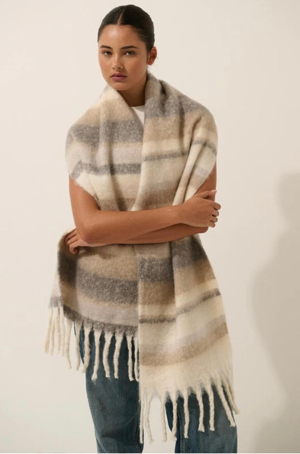 Our cosy Montana Neutral Stripes Fluffy Scarf features beautiful Earthy tones in a stripe pattern. It also has a wide width and long length, which makes it the perfect stylish add on accessory for that warm and cosy feeling during the autumn/winter season.

This scarf features:

Fluffy fabrication
Tassel ends
Heavy weight
Colour: Grey with Brown tones

Fabric: 100% Acrylic

Measurements: L: 227cm (Tassel to Tassel); W: 41cm