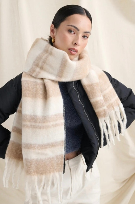 Our cosy Montana Neutral Stripes Fluffy Scarf features beautiful neutral tones in a stripe pattern. It also has a wide width and long length, which makes it the perfect stylish add on accessory for that warm and cosy feeling during the autumn/winter season.

This scarf features:

Fluffy fabrication
Tassel ends
Heavy weight
Colour: Brown 

Fabric: 100% Acrylic

Measurements: L: 227cm (Tassel to Tassel); W: 41cm