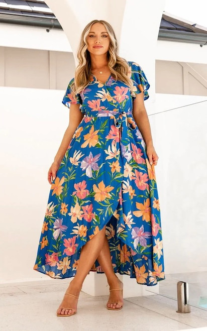Our Laura Maxi dress is fresh, bright and everything you need all year round With it's flowy style and flutter sleeves, it's sure to become one of your staples. Pair with nude strappy sandals in warmer months and our Flynn Ankle Boots and a denim jacket in cooler months.

This dress features:

Crossover V neckline with button closure
Flutter sleeves
Elasticised waist
Hi-Low hemline
Removable tie 
Lined to Knee
Maxi length
Colour: Blue with Bright Floral Print

Fabric: 100% Rayon

Size Guide: True to size. Model is wearing size 8.