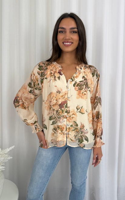 Refresh your wardrobe with our Meadow Bloom Floral Blouse, a timeless piece designed for effortless style. Showcasing a statement floral print in warm peach and blush tones, this blouse brings a touch of femininity to any look. The relaxed silhouette, button-down front, and shirred cuffs make it both comfortable and chic, perfect for casual weekends, office wear, or evenings out. Pair with your favourite denim for a casual-chic vibe or style with tailored pants and heels for an elevated look.
This blouse features:
Mandarin collar
Shirred neckline
Long sleeves with elastic cuffs
Button up front
Relaxed fit
Lined
Colour: Cream with Floral Print
Fabric: 80% Rayon, 20% Nylon; Lining: 100% Rayon
Size Guide: True to size. Model is 172cm tall and is wearing a size 8. Refresh your wardrobe with our Meadow Bloom Floral Blouse, a timeless piece designed for effortless style. Showcasing a statement floral print in warm peach and blush tones, this blouse brings a touch of femininity to any look. The relaxed silhouette, button-down front, and shirred cuffs make it both comfortable and chic, perfect for casual weekends, office wear, or evenings out. Pair with your favourite denim for a casual-chic vibe or style with tailored pants and heels for an elevated look.
This blouse features:
Mandarin collar
Shirred neckline
Long sleeves with elastic cuffs
Button up front
Relaxed fit
Lined
Colour: Cream with Floral Print
Fabric: 80% Rayon, 20% Nylon; Lining: 100% Rayon
Size Guide: True to size. Model is 172cm tall and is wearing a size 8.