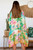 Escape to paradise with our vibrant Tropical Oasis Kimono! This stunning piece paints a picturesque scene of a lively tropical coastline, complete with lush palm trees, colourful hibiscus blooms, and charming beachside architecture. The brilliant turquoise, fuchsia, and sunny yellow hues create an uplifting and joyful palette, framed by a playful striped border. Crafted from a lightweight, flowing fabric, this kimono is your perfect companion for resort getaways, beach days or simply adding a burst of vacation cheer to your everyday look. Embrace the ultimate in summer style and effortless glamour.

Colour: Turquoise

Fabric: 100% Viscose

Size: OSFA
