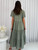 Discover effortless charm and ultimate comfort with our Annique Linen Blend Midi Dress. Featuring a stylish V-neckline with a button-front detail, delicate short sleeves, and a flowing tiered skirt, this dress combines classic elements with modern ease. The relaxed fit ensures comfort, while the practical side pockets add a touch of everyday convenience. Perfect for transitional seasons, casual outings or dressing up with accessories. Pair it with sandals for a breezy daytime look or elevate it with wedges and statement jewellery for a relaxed evening outing.

This dress features:

V-neckline
Short sleeves
Functional button up front
Functional side pockets
Tiered skirt and ruffled hemline
Linen front and skirt to knees
Relaxed fit
Colour: Khaki

Fabric: 70% Linen, 30% Viscose; Lining: 100% Rayon

Size Guide: Relaxed fit.