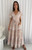 Step into style with our exquisite Kathleen Maxi Dress. Designed for the modern romantic, this beautiful dress features a flattering V-neckline, short flutter sleeves and adjustable drawstring waist ensure a comfortable and customised fit that accentuates your silhouette. This maxi dress boasts a graceful tiered skirt, beautifully detailed with charming white ric rac detailing. With convenient side pockets, it blends practicality with undeniable charm. Perfect for garden parties, beachside strolls or casual summer events, this dress will be your go-to for an effortlessly chic look. Pair it with sandals for a relaxed vibe or dress it up with wedges and accessories.

This dress features:

V neckline
Button up bust
Functional side pockets
Short sleeves sleeves with pic rac detailing
Elasticised waist with functional drawstring
Tiered skirt with ric rac detailing
Ruffled hemline 
Unlined
Maxi length
Colour: Natural with White Print

Fabric: 100% Rayon

Size Guide: True to size. Model is wearing size 8.