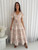 Step into style with our exquisite Kathleen Maxi Dress. Designed for the modern romantic, this beautiful dress features a flattering V-neckline, short flutter sleeves and adjustable drawstring waist ensure a comfortable and customised fit that accentuates your silhouette. This maxi dress boasts a graceful tiered skirt, beautifully detailed with charming white ric rac detailing. With convenient side pockets, it blends practicality with undeniable charm. Perfect for garden parties, beachside strolls or casual summer events, this dress will be your go-to for an effortlessly chic look. Pair it with sandals for a relaxed vibe or dress it up with wedges and accessories.

This dress features:

V neckline
Button up bust
Functional side pockets
Short sleeves sleeves with pic rac detailing
Elasticised waist with functional drawstring
Tiered skirt with ric rac detailing
Ruffled hemline 
Unlined
Maxi length
Colour: Natural with White Print

Fabric: 100% Rayon

Size Guide: True to size. Model is wearing size 8.