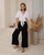 Designed for the modern woman who values both style and comfort, our Natalie Linen Blend Wide Leg Pants offer a flattering silhouette and luxurious feel. Crafted from a beautiful, soft linen/silk blend, they're perfect for warm weather and versatile enough to transition from casual daytime outings to chic evening gatherings. Featuring a comfortable high waist and a relaxed, flowing fit, our Natalie pants pair seamlessly with everything from fitted tops to oversized blouses. Elevate your wardrobe with this essential piece that promises both timeless appeal and ultimate comfort.

These pants feature:

Double button and zip front closure
Wide leg design
Functional side pockets
Linen/silk blend
Unlined
Colour: Black

Fabric: 55% Linen; 45% Silk

Size Guide: True to size. Stick to your usual size