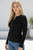 Black Maxine Ribbed Knit Top with gold button henley neckline and fitted ribbed fabric styled with high-rise blue jeans.