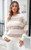 Model wearing the Alison Cotton Blend Knit with high waist white jeans