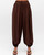 Woman wearing chocolate-brown Janet balloon pants with an elasticated waist and gathered ankle cuffs.