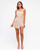 Model wearing the Harper beige playsuit with a square neckline, thin shoulder straps, belted waist and wrap-style skirt overlay.