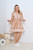 Effortless and feminine, our Tammie Boho Dress features a relaxed fit with flattering V-neckline, button front, drawstring waist, long sleeves and tiered ruffled trimmed hem. It's the perfect boho-chic dress for casual weekends, brunch dates or beachside getaways. Pair with sandals for a fun day at the beach or sneakers when running errands.

This dress features:

V-neckline
Functional drawstring waist with silver caps
Long, balloon sleeves
Button up bust
Tiered skirt
Ruffled hemline
Unlined
Colour: Sand with White Print

Fabric: 100% Rayon

Size Guide: True to size. Model wears a Size 8.