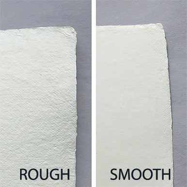 small square sheet of blank white Khadi paper against beige rag