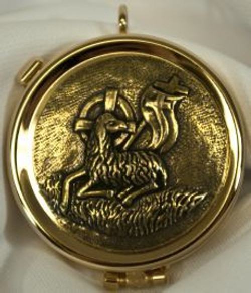 textured lamb of peace Pyx made of brass with 24 karat gold plate measures 2 by 5 eighths inches with attached loop and metal clasp holds up to 6 hosts SALART525 textured lamb of peace Pyx made of brass with 24 karat gold plate measures 2 by 5 eighths inches with attached loop and metal clasp holds up to 6 hosts SALART525