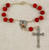 red auto rosary beads one decade with budded cross crucifix and printed saint therese centerpiece MAAR2C red auto rosary beads one decade with budded cross crucifix and printed saint therese centerpiece MAAR2C