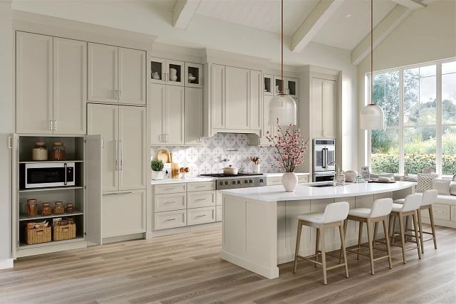 Two-tone kitchen with light perimeter cabinets and a dark charcoal island