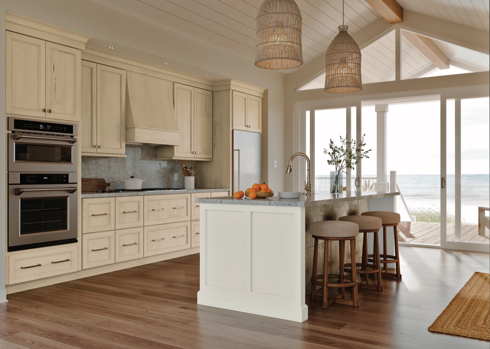 Coastal kitchen with cream maple cabinets, a white island, and an ocean view