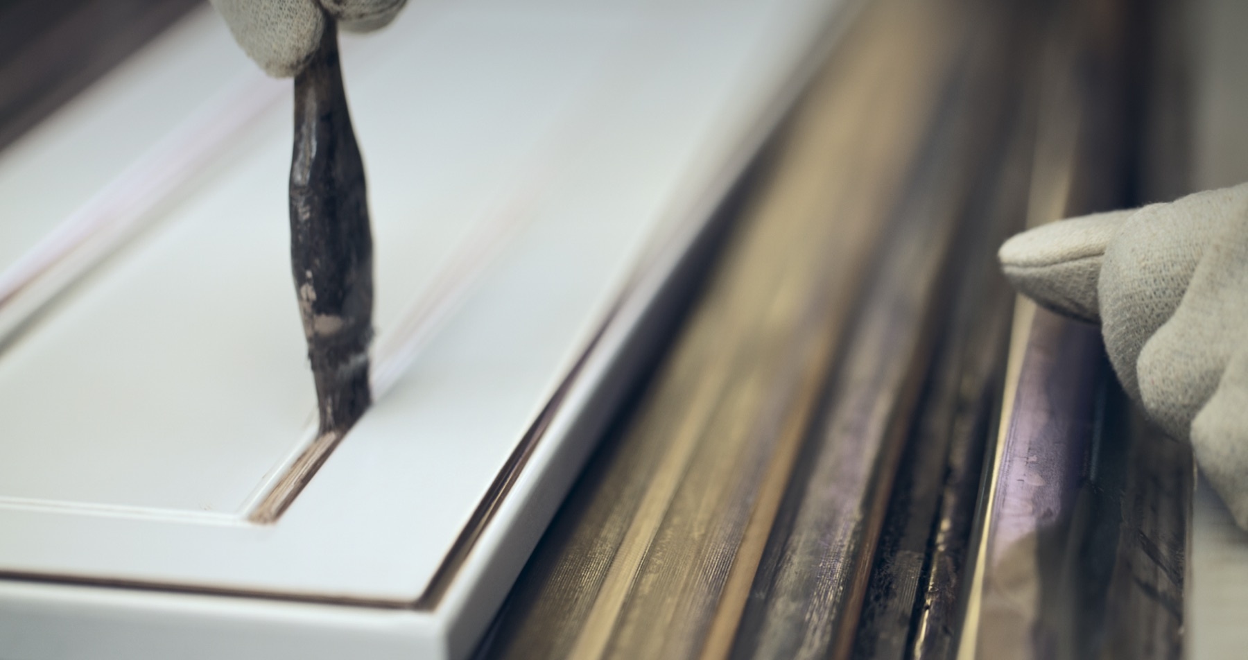 KraftMaid craftsperson finishing a cabinet door