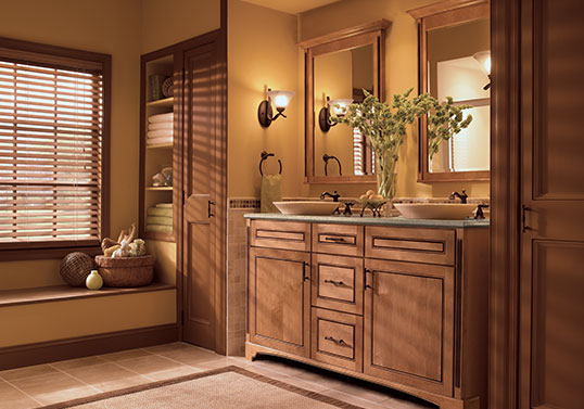 Transitional bathroom with two vessel sinks on top of a KraftMaid vanity in Ginger with Sable Glaze