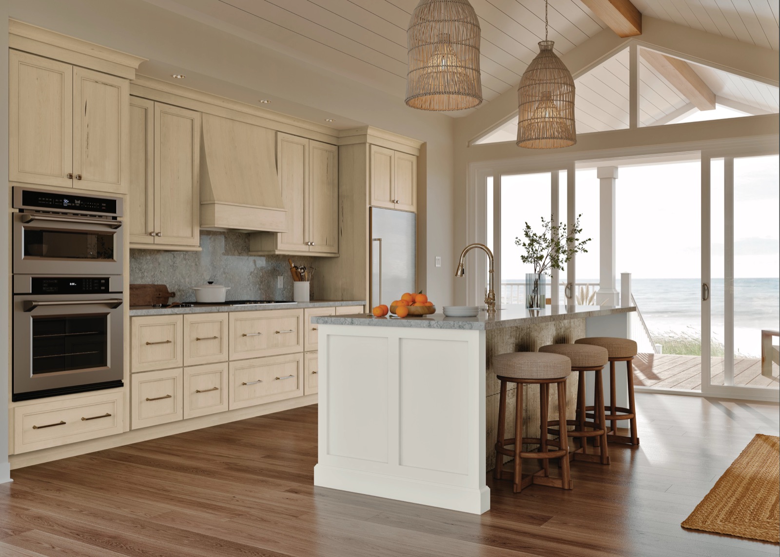 Coastal kitchen with cream maple cabinets, a white island, and an ocean view