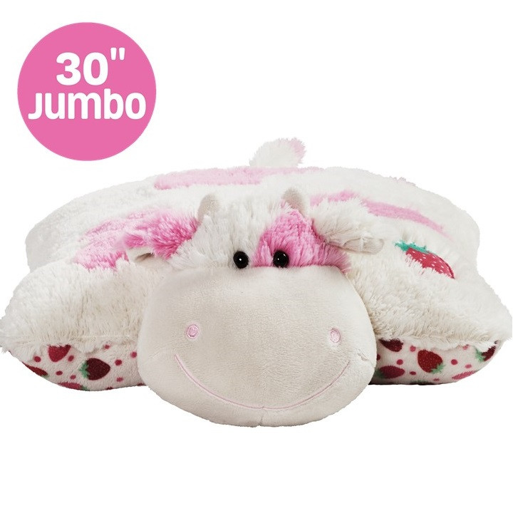 Sweet Scented Strawberry Cow Jumbo 30in Pillow Pet unfolded in plush pillow form, featuring soft white fur with pink spots, and embroidered strawberry details.