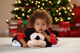 Child resting on the Mickey Mouse Pillow Pet unfolded into a soft plush pillow.