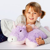 Lifestyle Image of little girl cuddling the Magical Unicorn Pillow Pet.
