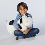 Lifestyle image of little boy hugging the Cozy Cow Pillow Pet.