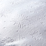 Close-up of the Olaf Pillow Pet's soft white plush fabric featuring an embossed snowflake pattern.