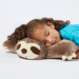 Little girl sleeping while cuddling the Sunny Sloth Pillow Pet unfolded in pillow form, using it as a soft, comfy pillow.