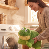 lifestyle image of a mom placing the frog pillow pet in a washing machine
