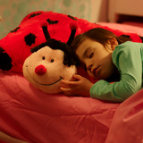 Little girl sleeping while cuddling the Ms. Ladybug Pillow Pet.