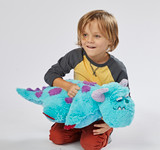 Little boy smiling playing with the Sulley Pillow Pet in plush character form.