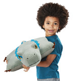 Little boy smiling holding the Jurassic World's Velociraptor Blue Pillow Pet.