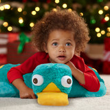 Little kid lying on the Perry the Platypus Pillow Pet unfolded in pillow form.