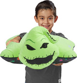 Little boy smiling holding the Oogie Boogie Pillow Pet.