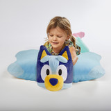 Little girl playing lying on the Jumbo Bluey Pillow Pet in pillow form.