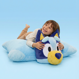 little boy lying on a jumbo bluey pillow pet.