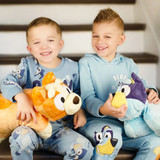 Lifestyle image of children smiling while holding the Bluey and Bingo Pillow Pets.