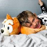 Little boy cuddling the Bingo Pillow Pet.