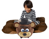 Little boy sitting on the Jumbo Freddy Fazbear Pillow Pet in pillow form while reading a book.