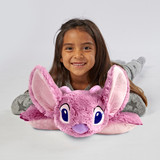 Little girl lying on the Angel Pillow Pet in pillow form, featuring Angel's pink fur, large ears, and purple nose.