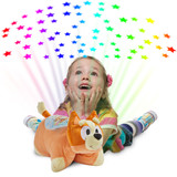 Little girl playing beside the Bingo Sleeptime Lite while it projects colorful rainbow stars onto the ceiling.